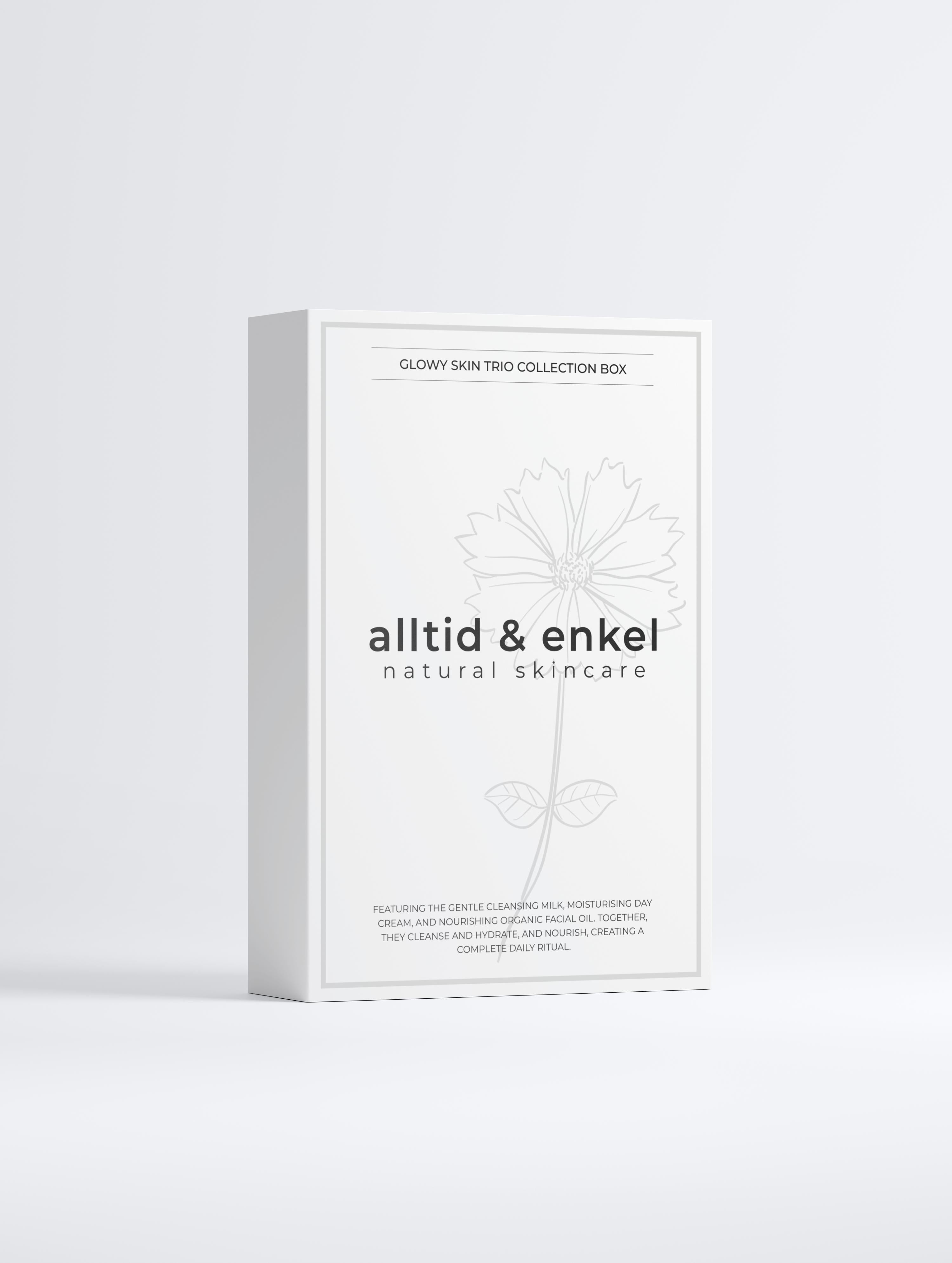 Glowy skin trio collection in a sleek white box from the front on a white background.